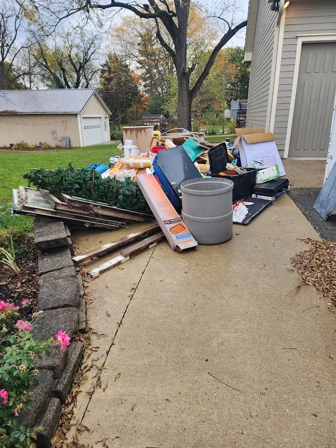 Dumpster being loaded with debris for 10 Yard Dumpster Rental in Lee's Summit